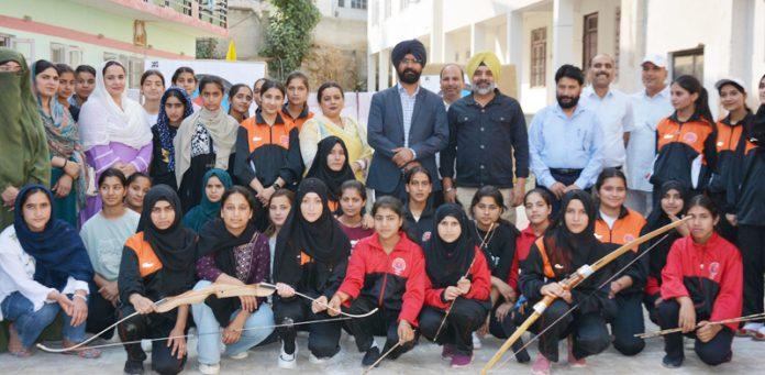 Young Archers posing along with Brigadier PS Cheema, DC Doda Harvinder Singh and others during an event.