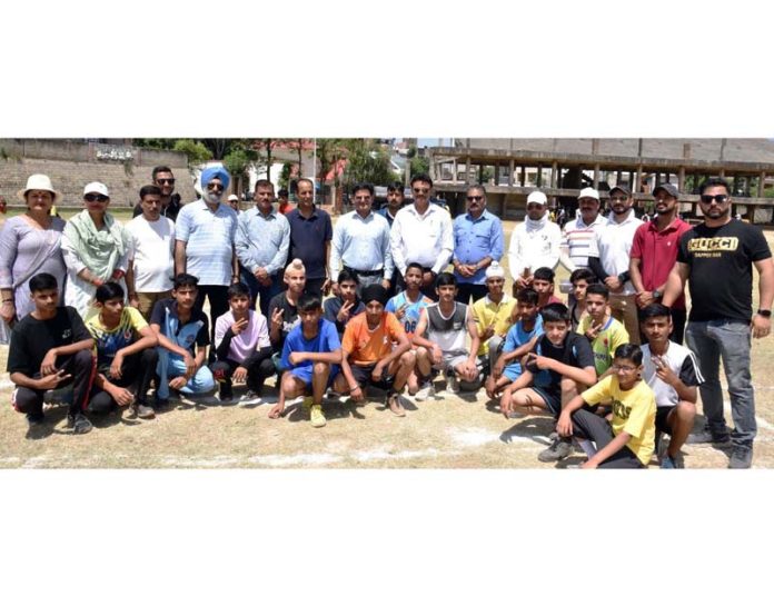 Participating players and others pose for a group photograph on culmination of Zonal Level Inter-School Athletic Meet at Subhash Stadium Udhampur.