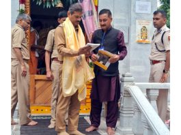 DGP RR Swain being presented with a book on Sharda temple at Teetwal in Kupwara district on Saturday.