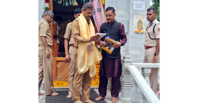 DGP RR Swain being presented with a book on Sharda temple at Teetwal in Kupwara district on Saturday.