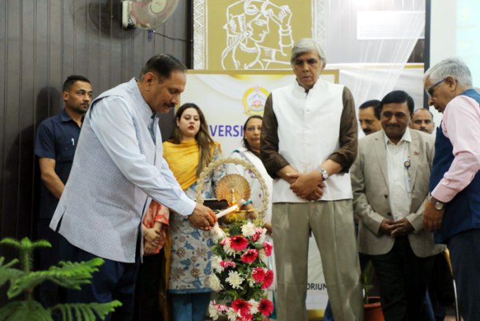 Advisor Rajiv Rai Bhatnagar lighting ceremonial lamp during inaugural of lecture series at JU on Monday.