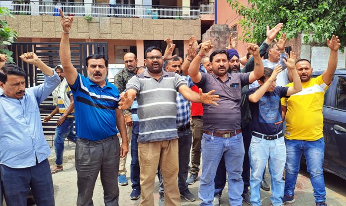 PHE daily wage workers staging protest outside Chief Engg's office at B C Road in Jammu on Wednesday. -Excelsior/ Rakesh
