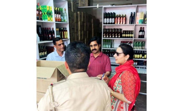 Deputy Excise Commissioner Executive, Jammu, Kusum Sharma and other officers during surprise inspection of a liquor shop.
