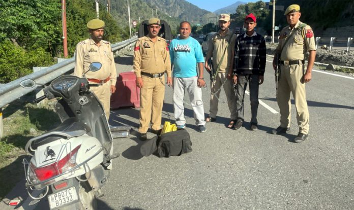 Cops displaying recovered intoxicants with peddlers in Ramban on Tuesday.