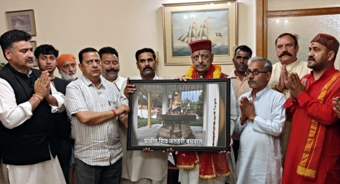 Senior BJP leader Devender Singh Rana receiving portrait from the SMVD Sanstha delegation in Jammu on Friday.