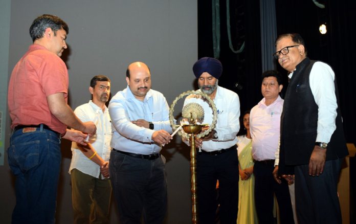 Guests lighting ceremonial lamp during inaugural of the workshop at SMVDU.