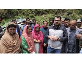 Dy Commissioner Poonch Yasin Mohd Choudhary providing relief to house damage victims in Mandi area. -Excelsior/Waseem