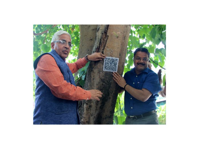 JU Vice-Chancellor displaying the QR Code installed on a campus tree. —Excelsior/Rakesh