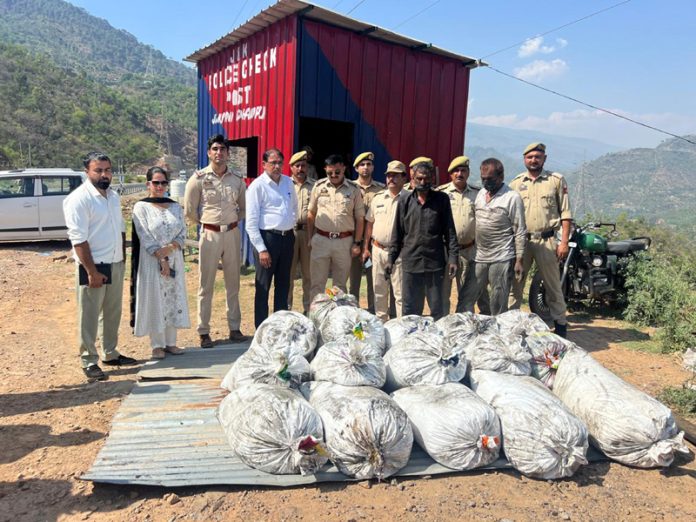 Police team displaying seized consignment of poppy straw.