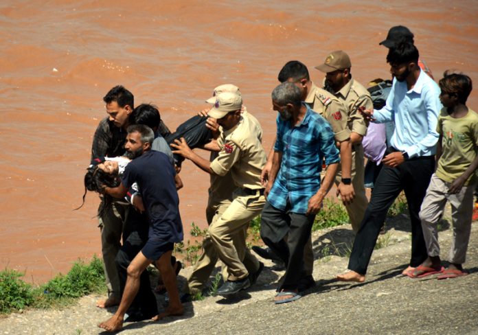 Police and locals rescuing a girl who jumped into Tawi River in Jammu on Tuesday. -Excelsior/Rakesh