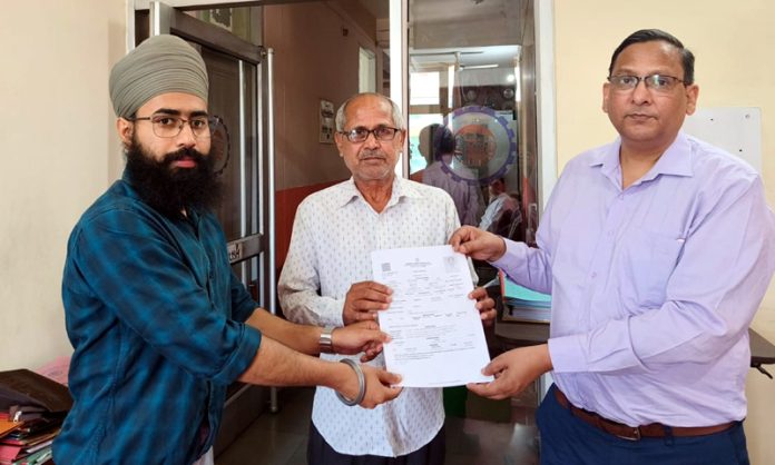 Rizwan Uddin, Regional PF Commissioner J&K and Ladakh issuing a PPO to a beneficiary in Jammu on Wednesday.