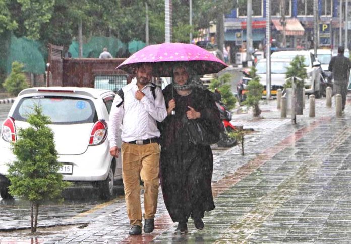 Rain lashes Srinagar on Friday.(UNI)