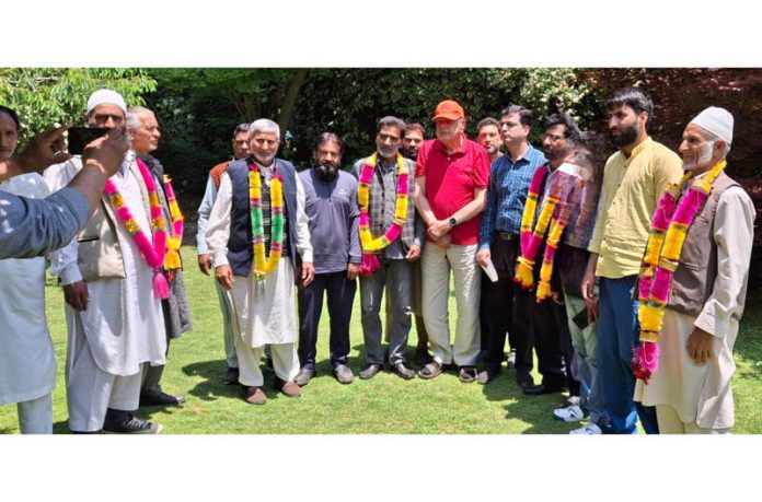 NC president Dr Farooq Abdullah posing along with the workers who joined the party in Srinagar on Thursday.