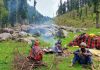 Nomadic people perform daily activities at a higher altitude meadow in Doda district.