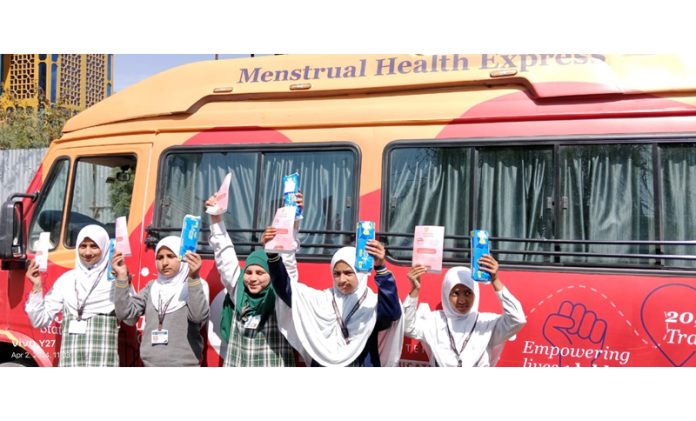 Students posing along with Ujaas Menstrual Health Express van in Jammu.