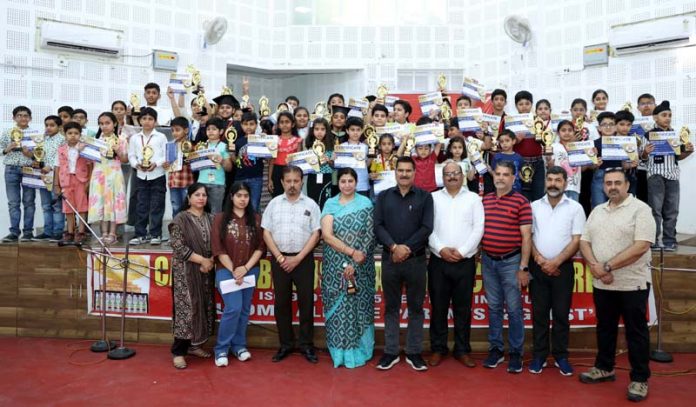 Former Dy Mayor and BJP spokesperson, Purnima Sharma along with other party leaders posing with meritorious students of Career Abacus Coaching Centre at Jammu on Sunday.