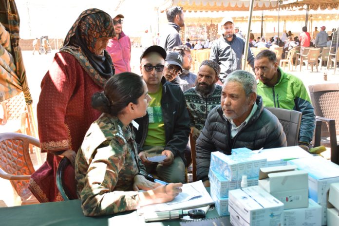An Army Doctor checking a patient during a camp at Dras area of Kargil on Thursday.