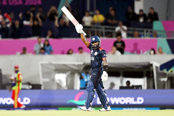 USA’s Aaron Jones raising his bat after scoring 94 runs of 40 balls against Canada.