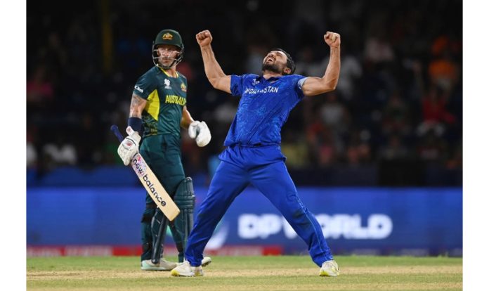 Gulbadin Naib flexes his biceps after taking wicket against Australia.