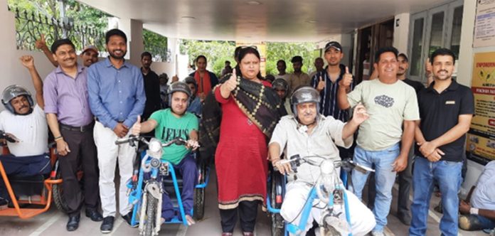 Officials of ALIMCO and CRC posing with PwDs after providing them motorized tricycles in Jammu.