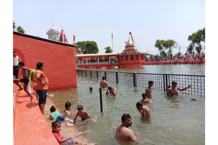 Devotees taking a holy dip in 'Sarovar' at Baba Sidh Goria Shrine, Swankha in Ramgarh Sector of Samba district.