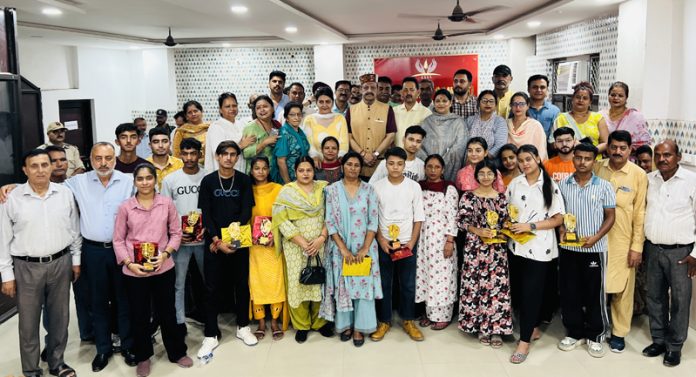 Devendra Singh Rana and others with meritorious students during felicitation ceremony.