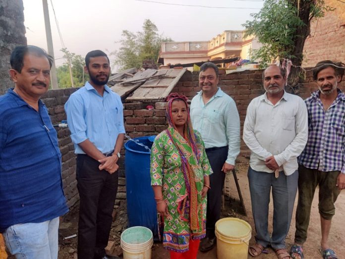 Jubilant villagers of Gharota in Jammu posing for a photograph after getting first tube-well after independence.