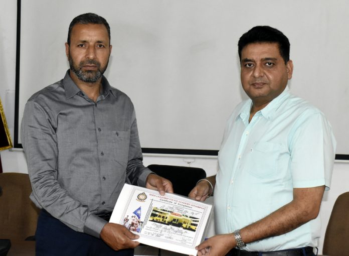 The chief guest giving certificate to a participant on culmination of course on 'Anti-Human Trafficking' at SKPA in Udhampur.