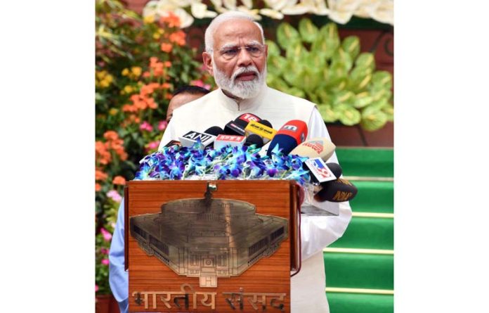 Prime Minister Narendra Modi talking to newsmen on arrival at Parliament House in New Delhi on Monday. (UNI)