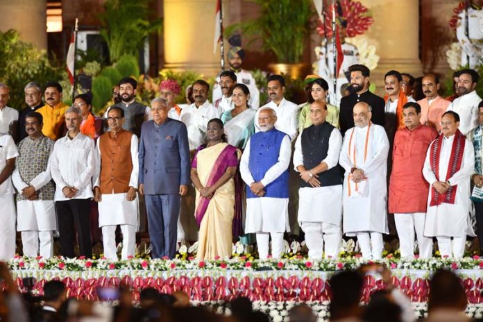 President Droupadi Murmu and Prime Minister Narendra Modi pose for a photograph with new Council of Ministers at the swearing in ceremony at Rashtrapati Bhavan in New Delhi on Sunday. (UNI)