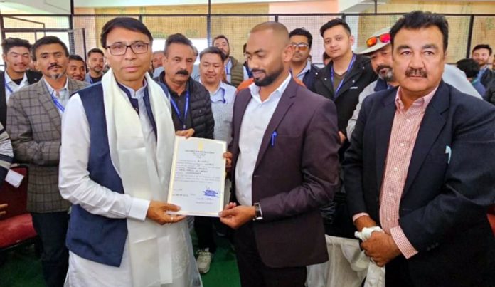 Haneefa Jan receiving the victory certificate from the Returning Officer Santosh Sukhadeve in Leh. -Excelsior/Basharat Ladakhi