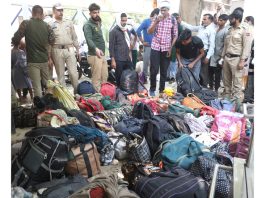 Relatives searching for belongings of their dead relatives at GMC Jammu. —Excelsior/Rakesh