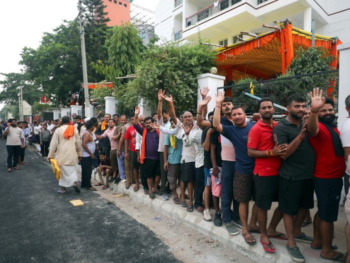 Amarnath Ji Yatris waiting in a large queue in front of Saraswati Dham near Railway Station, Jammu for their registration on Wednesday. -Excelsior/Rakesh