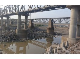 Pillars of Ravi-Tawi canal bridge and railway bridge exposed after mining in Basantar river of Samba. - Excelsior/Nischant