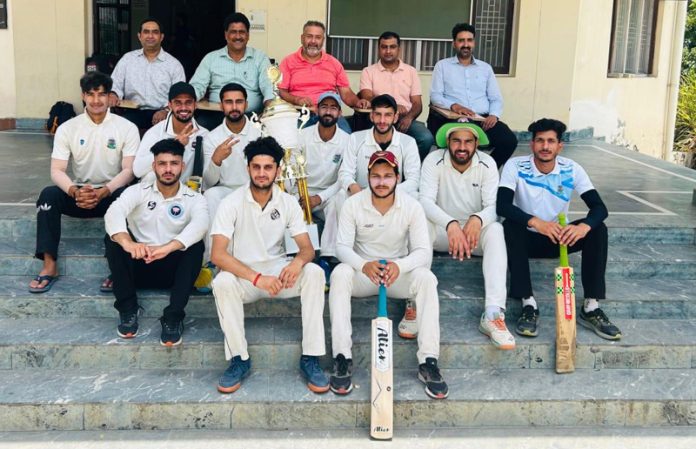 Winning team posing along with trophy during Inter-departmental Cricket (M) tournament of the Jammu University on Thursday.