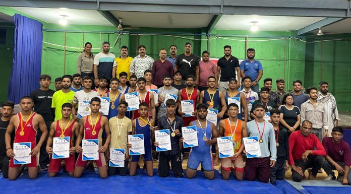 Wrestlers posing along with medals and certificates during concluding ceremony at Jammu University.