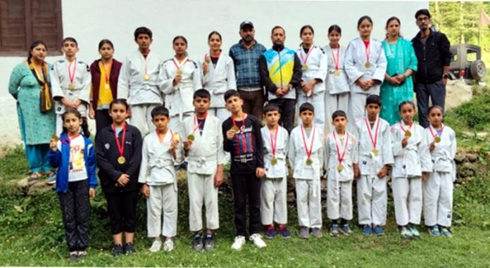 Judo players posing along with medals at Bhaderwah.