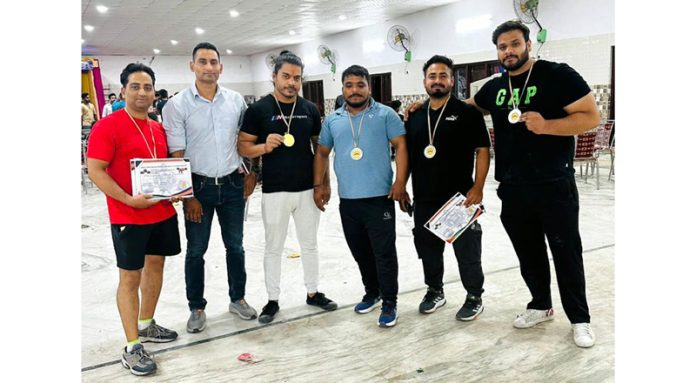 Team Master Fitness Club posing along with medals.