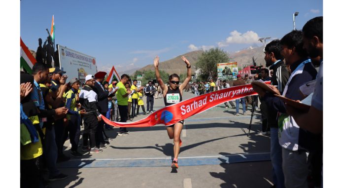 A Female athlete celebrating after completing her run in Ladakh.