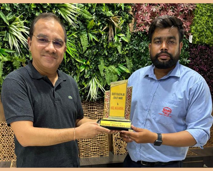 Anil Aggarwal receiving an award from Saurabh Jangral of Merino Industries in Jammu on Wednesday.