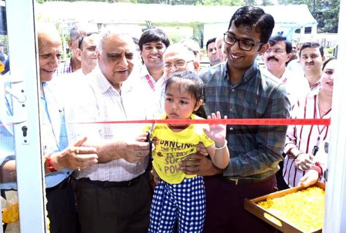 SMVD Shrine Board's CEO Anshul Garg and Member Dr Ashok Bhan facilitating a little girl to cut the ribbon during inaugural of Plant Sale Counter.