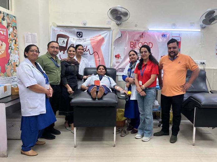 A staff nurse donating blood during a camp at GMC Jammu.