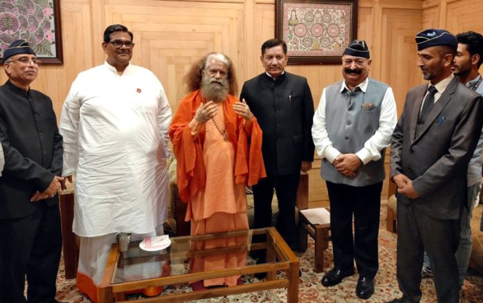 Swami Chidanand Saraswati and other guests during a programme at SKICC in Srinagar.