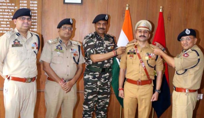 ADGP Jammu, Anand Jain, pinning rank on newly promoted SP, Mohan Lal, at ZPHQ Jammu on Friday.