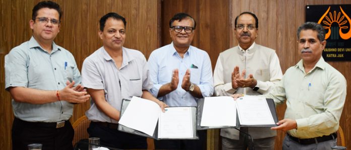 Registrars of SMVDU and SKUAST-Jammu displaying copies of MoU in presence of their Vice-Chancellors.
