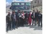 Commuters posing in front of HRTC bus at Kargil in Ladakh.