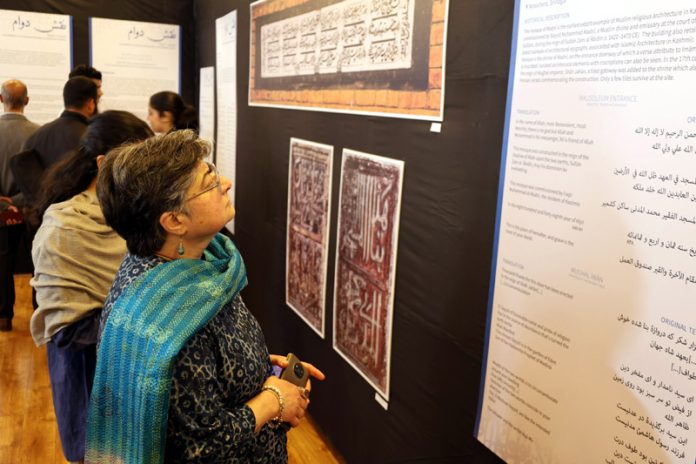 Visitors during the week-long exhibition on architectual epigraphy held at Kashmir Art Emporium in Srinagar on Saturday. -Excelsior/Shakeel