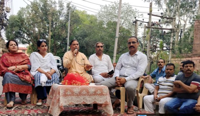 Former BJP president and ex Minister, Sat Sharma listening public grievances at Krishna Nagar, Jammu on Friday.