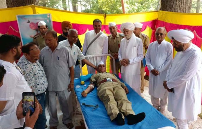 Volunteers donating blood during a camp organised by Sant Nirankari Mission at Patnitop on Wednesday.