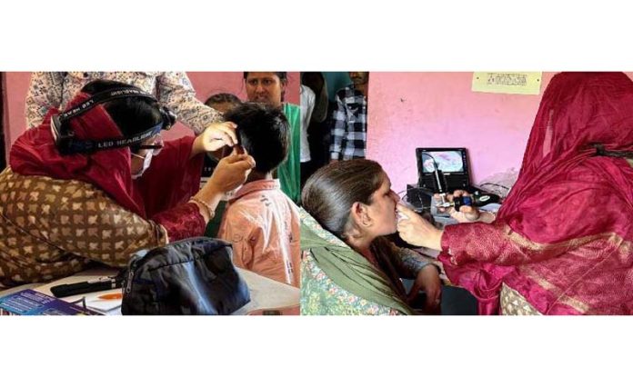Doctors conducting ENT check-up during medical camp.